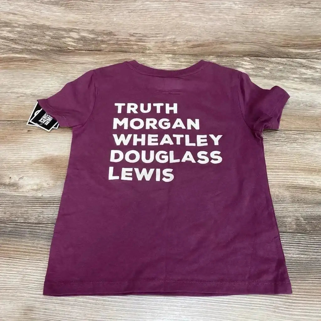 Back view of purple toddler T-shirt (4-5T) showing white block names TRUTH, MORGAN, WHEATLEY, DOUGLASS, LEWIS on wood background