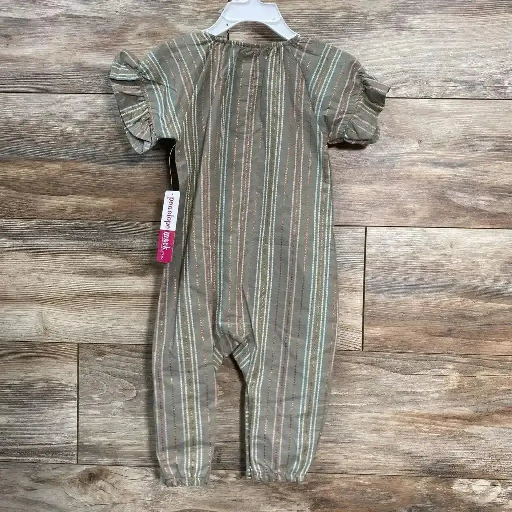Front view of green striped Penelope Mack Henley jumpsuit (12m) with ruffle sleeves and elastic ankle cuffs on wood floor