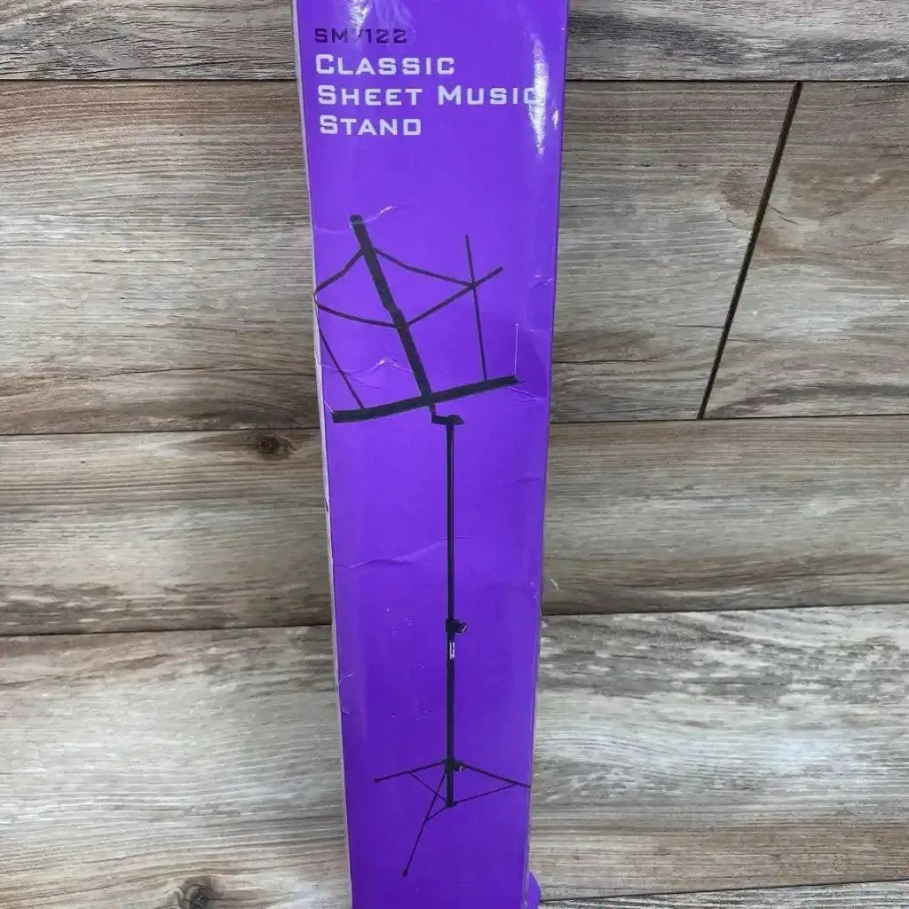 Front view of boxed On Stage compact folding sheet music stand showing illustrated assembled stand with tripod base on a purple box against a wood background