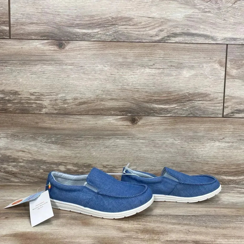 Side view of Cat and Jack Bergen toddler slip-on sneakers, blue canvas upper and white rubber sole, size 3Y on wood-look floor