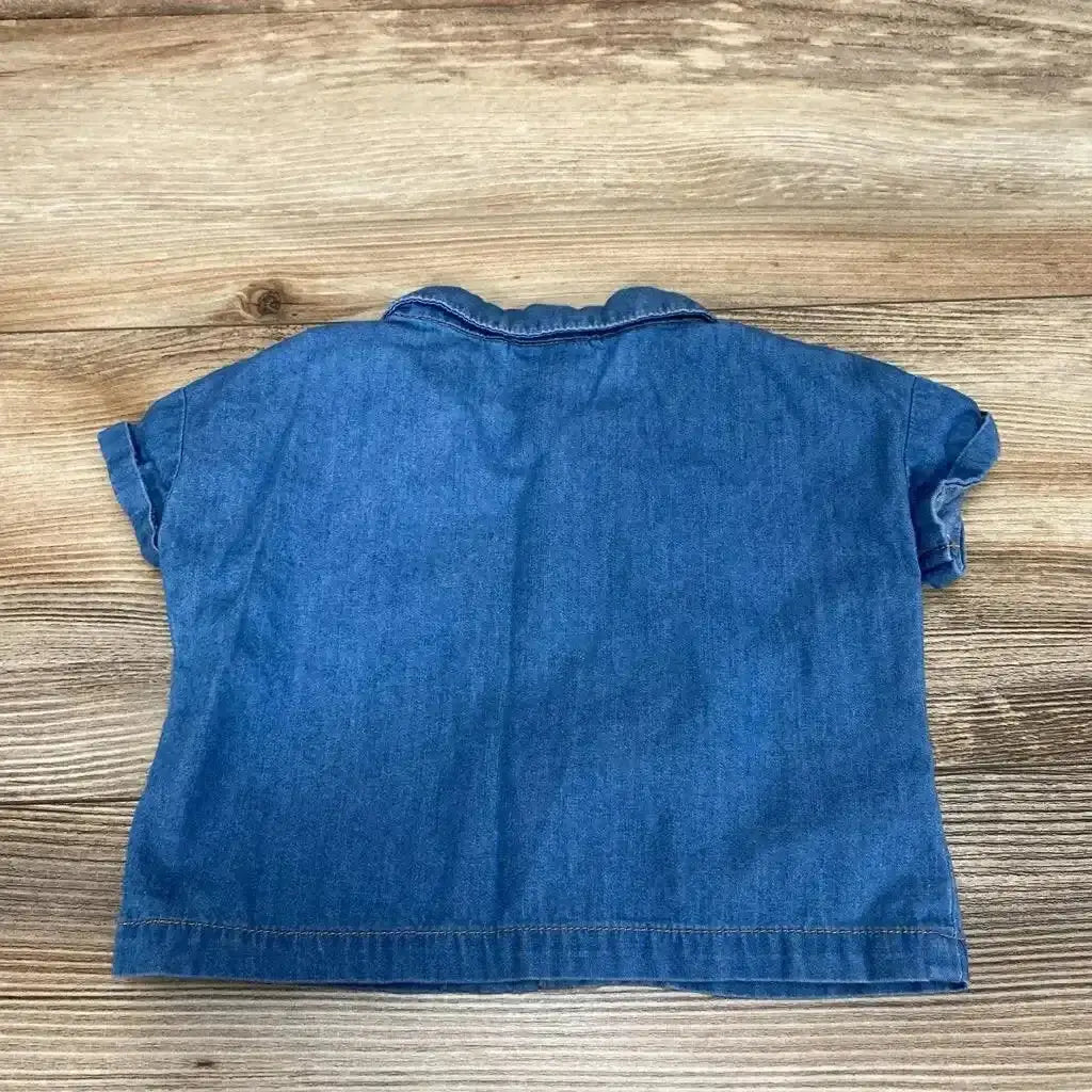 Front view of blue chambray baby button-up shirt 0 to 3 months showing front buttons and chest pocket on white background