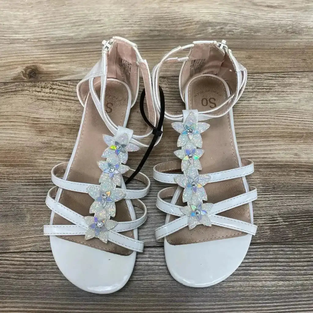 Top view of white New SO Tangelo girls' sandals size 3Y showcasing holographic flower embellishments on T-strap with wood-grain background