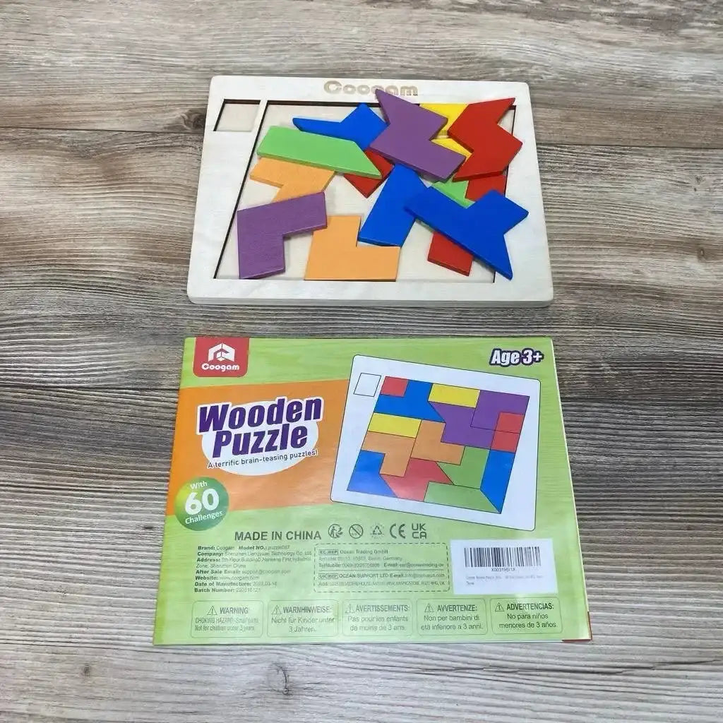 Top view of Coogam wooden puzzle showing colorful interlocking shapes on a wooden board with its green box on a wood table