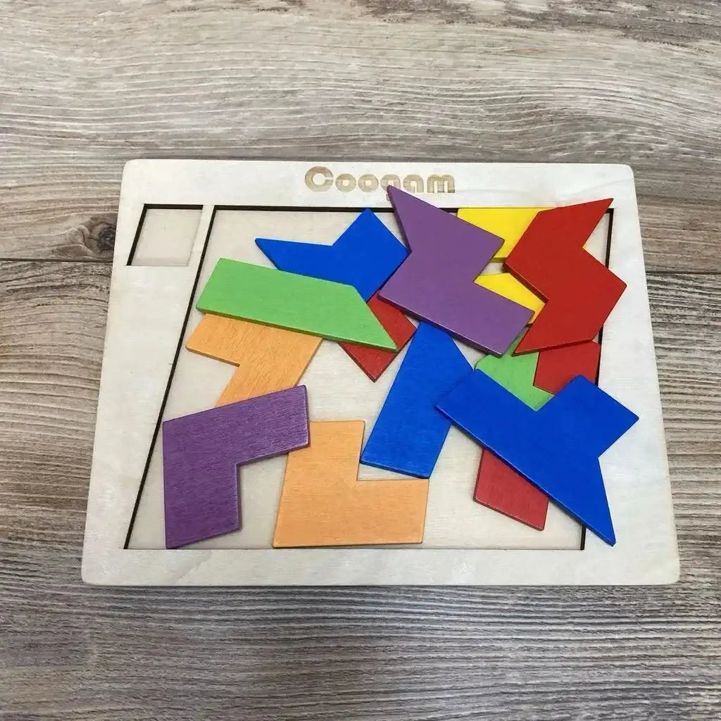 Top-down view of Coogam wooden puzzle showcasing multicolored geometric pieces in light wood frame on a wood surface