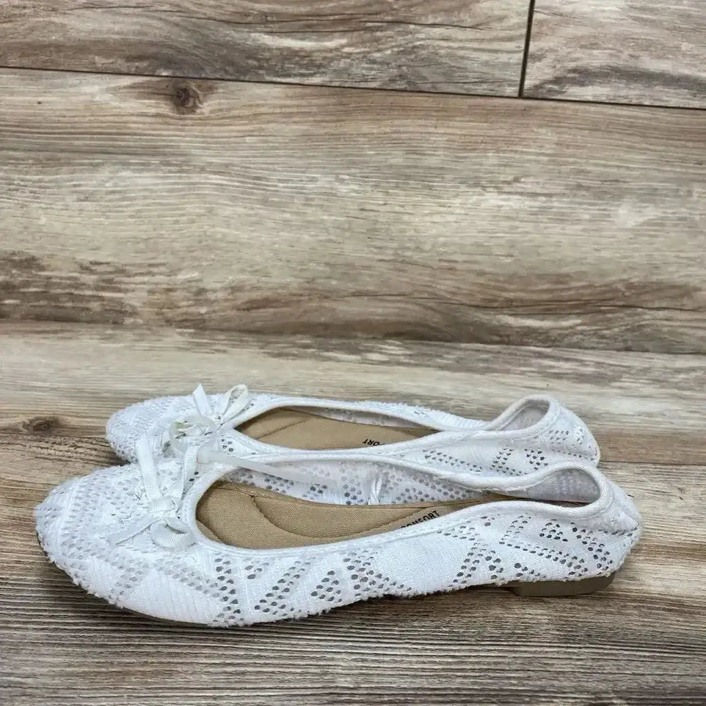 Side view of white SO Pensacola bow ballet flats (size 6Y) showing front bow detail and light wear on plain background