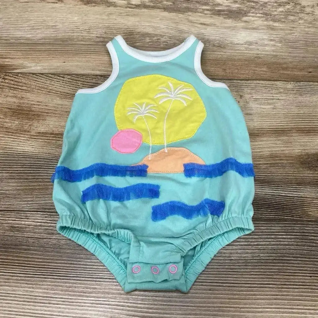 Flat-lay front of blue Cat and Jack baby romper with beach applique, palm trees and blue fringe waves on wood background