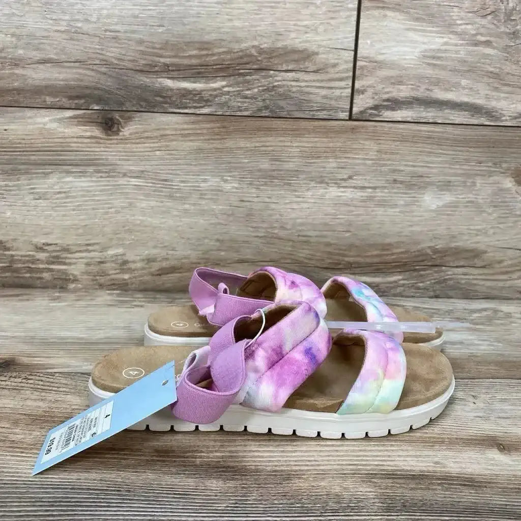 Side view of Cat & Jack Hazel girls' slip-on sandals size 4Y in pink tie-dye showing padded crisscross straps and elastic heel strap on wood floor