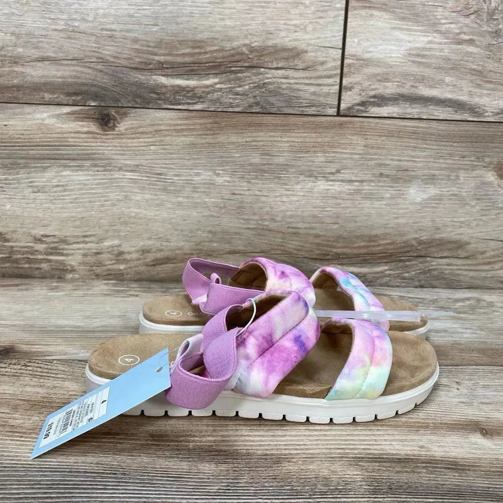 Side view of Cat & Jack Hazel girls' slip-on sandals size 4Y in pink tie-dye showing padded crisscross straps and elastic heel strap on wood floor