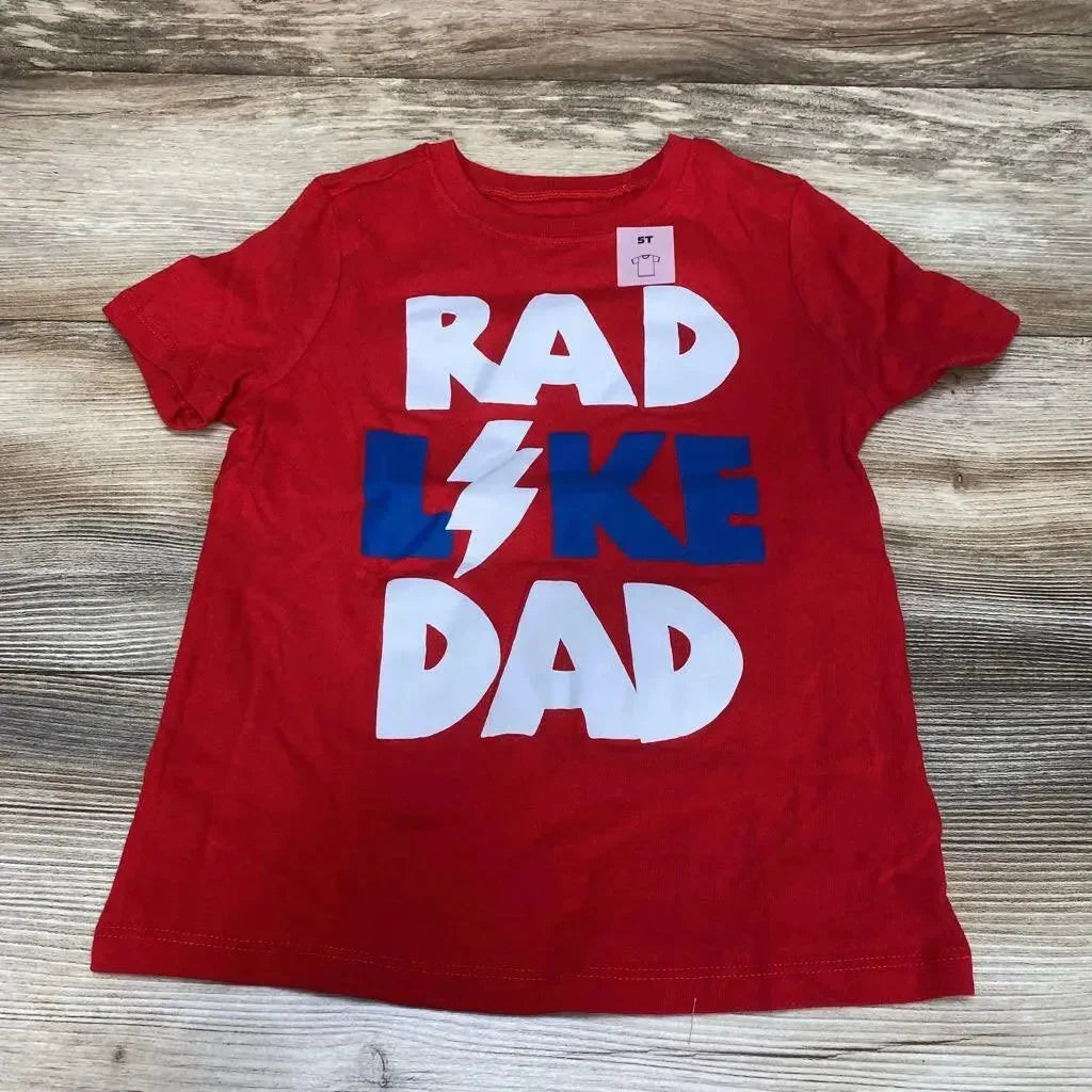 Flat lay of Old Navy red toddler T-shirt (size 5T) showcasing large white and blue "RAD LIKE DAD" graphic on wood background