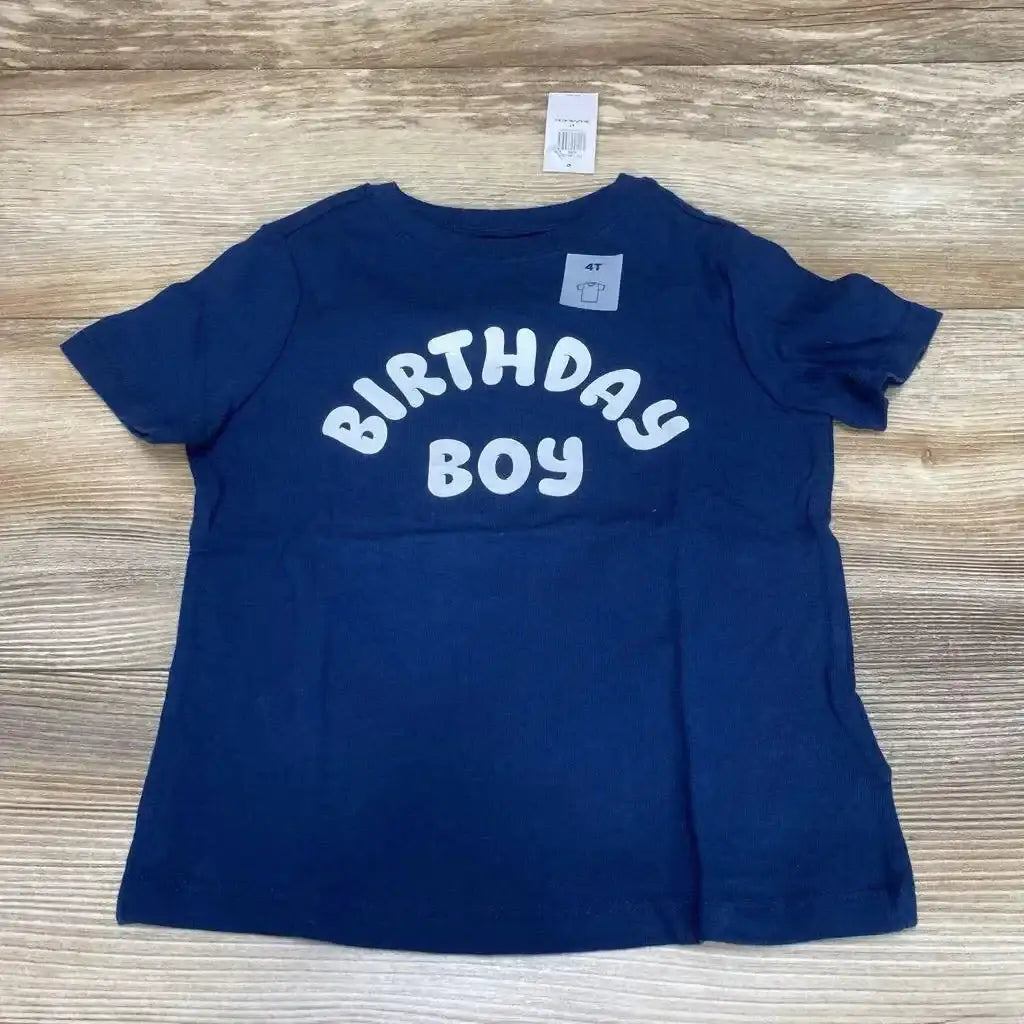 Front view flat lay of NEW Old Navy Birthday Boy tee in navy with white puff print and hangtag sz 4T on wood plank floor