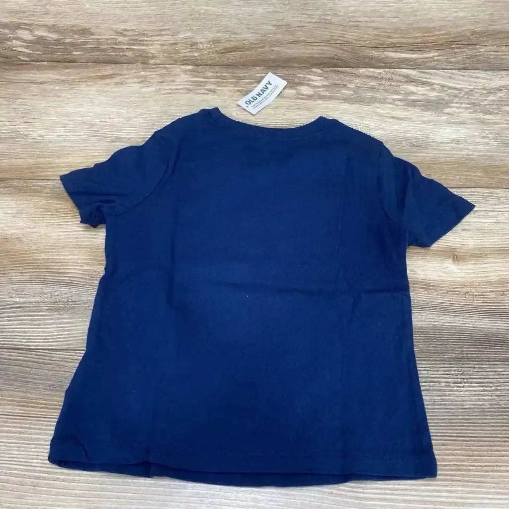 Back view flat lay of new Old Navy navy blue short sleeve Birthday Boy tee with brand neck tag on wood plank floor