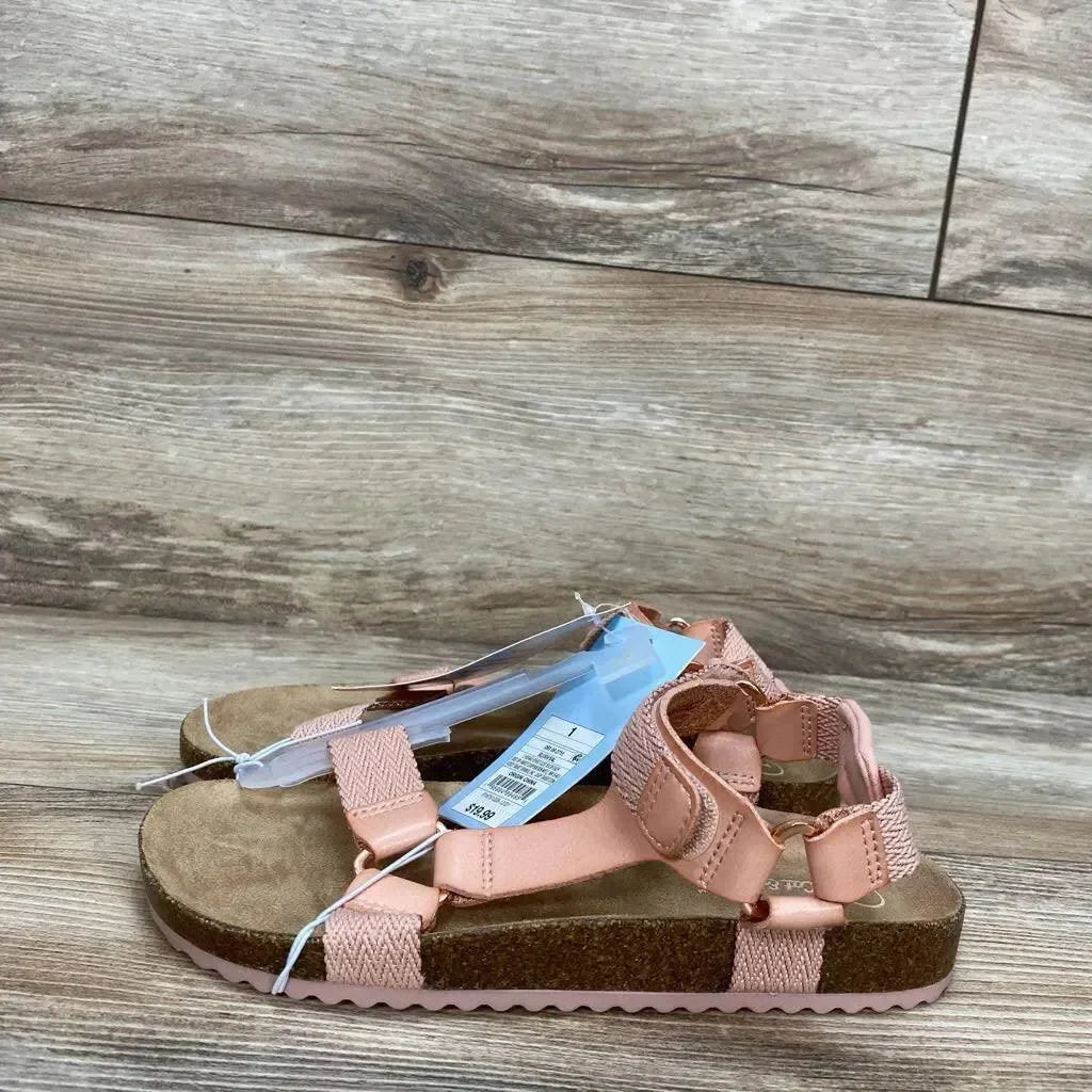 Side view of Cat and Jack Val toddler sandal in blush pink showing cork footbed and adjustable Velcro straps on wood floor