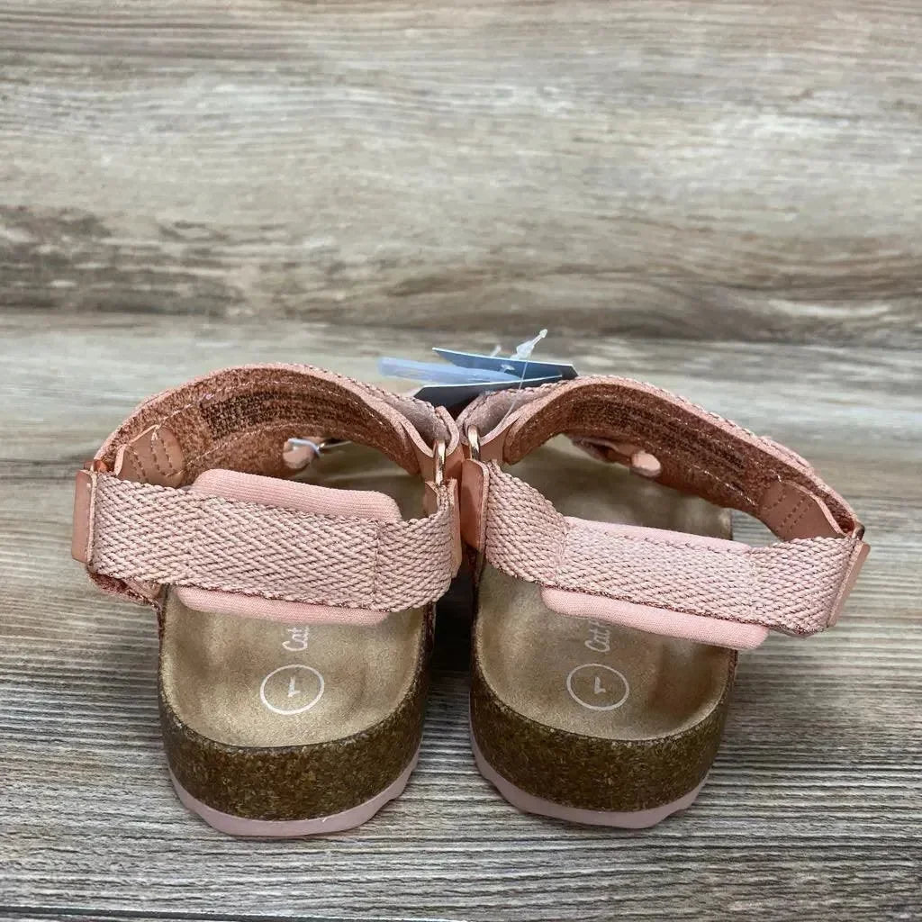 Rear view of blush Cat & Jack toddler footbed sandals (size 1Y) showing cork footbed and adjustable pink hook-and-loop straps on wood surface
