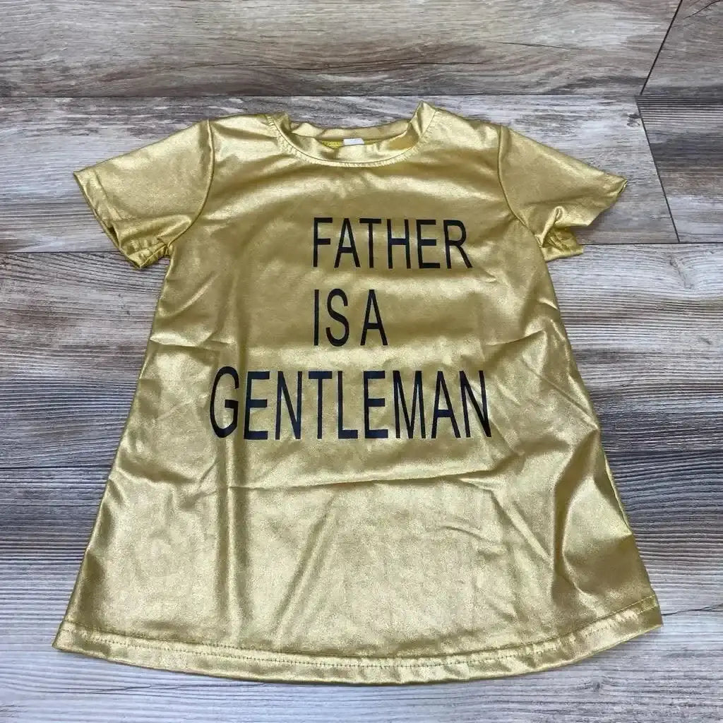 Flat-lay of gold toddler shirt dress (2T) with black 'FATHER IS A GENTLEMAN' text, short sleeves, on wood floor
