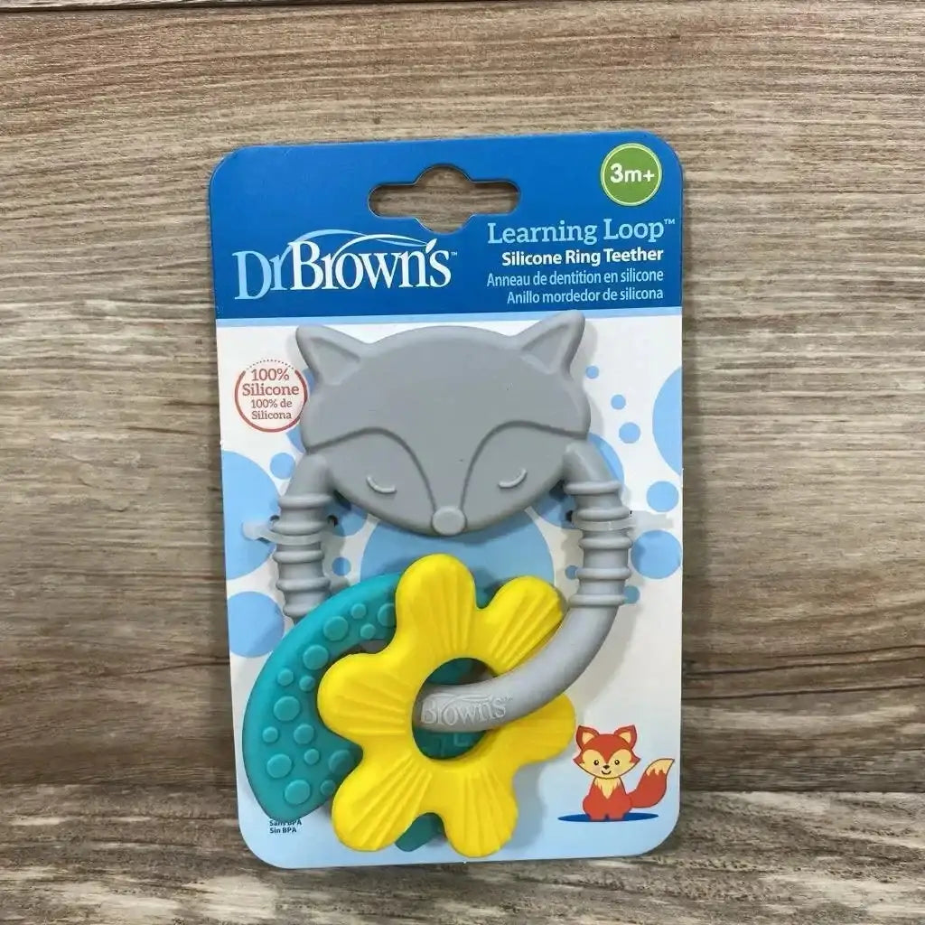 Front view of Dr Brown’s Learning Loop Silicone Teething Ring with grey fox teal and yellow shapes in original 3m+ packaging on wood plank floor
