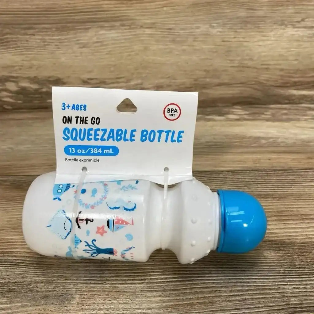 New Brite Concepts On The Go BPA-free squeezable bottle 13oz with blue ocean print and original hangtag on wood plank floor