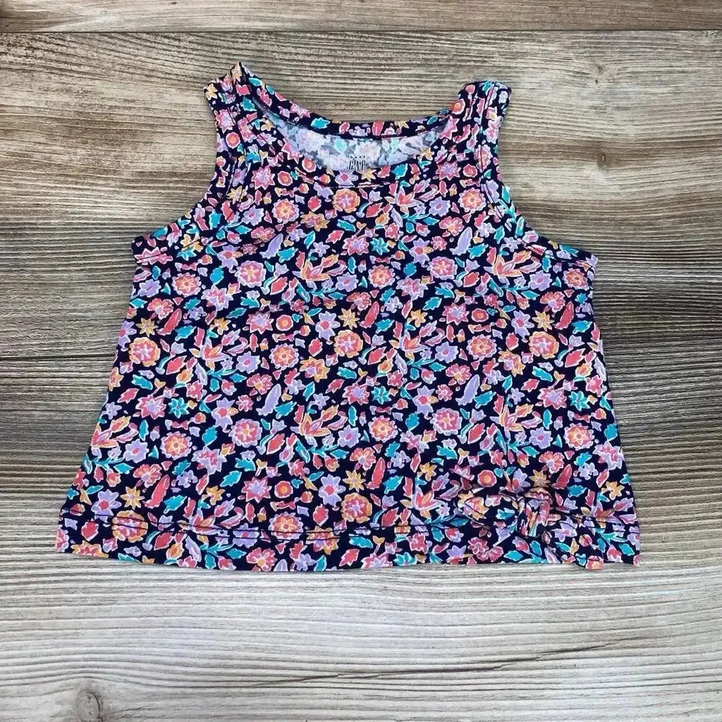 Flat lay of navy Baby Gap tank top size 3-6 months showcasing all-over floral print and front-tie detail on wood background