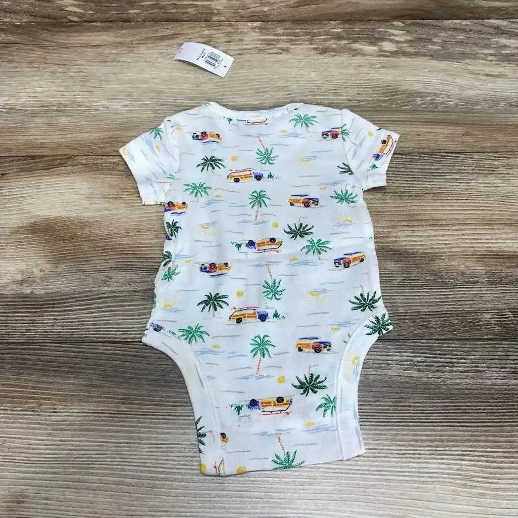 Back view of NWT Old Navy short sleeve bodysuit in white with beach print of palm trees and woody surf wagons on wood plank floor