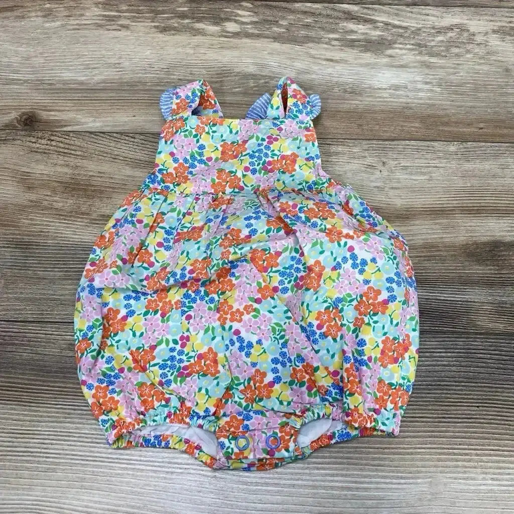 Top view of Baby Boden bubble romper (3-6m) showing floral print, ruffle straps, and elasticized legs on wood