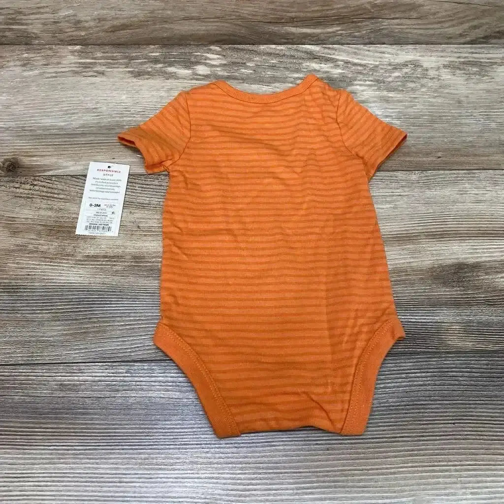 Flat lay of orange striped Cat & Jack baby bodysuit 0-3m showing short sleeves and snap leg openings on wood plank background