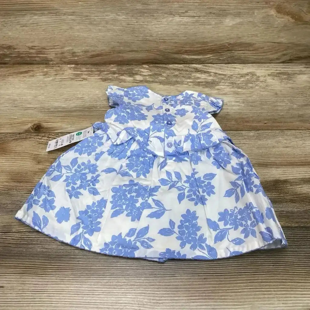 Back view of NEW Just One You 2pc Floral Dress and Bloomers showcasing blue floral print on white with button back ruffle bodice and hangtag on wood plank floor