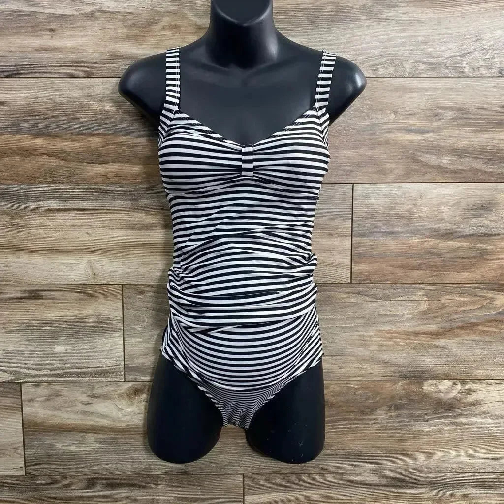 Front view of black and white striped tankini set showcasing ruched maternity tummy panel and fitted top on black torso mannequin against wood background