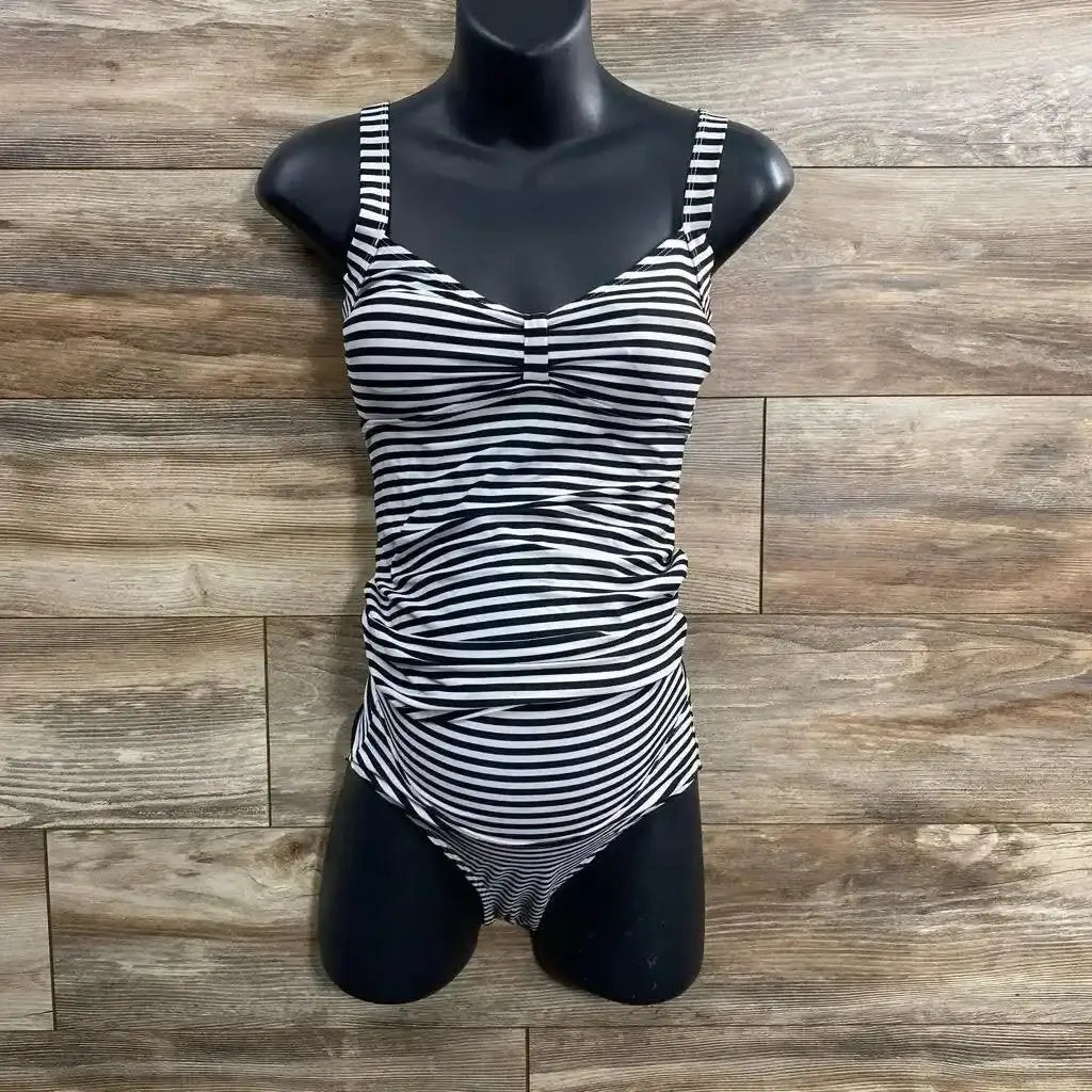 Front view of black and white striped tankini set showcasing ruched maternity tummy panel and fitted top on black torso mannequin against wood background