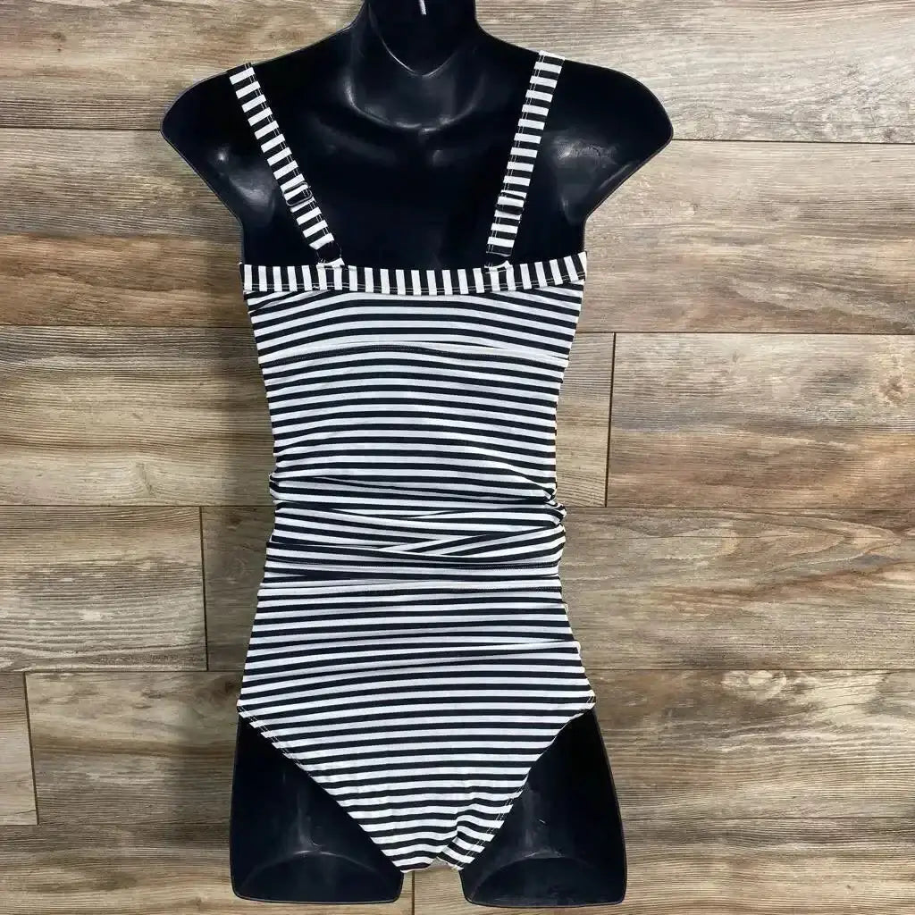 Front view of Jojo Maman Bebe striped tankini set on mannequin showing black-and-white stripes, tank straps, and ruched waist on wood background