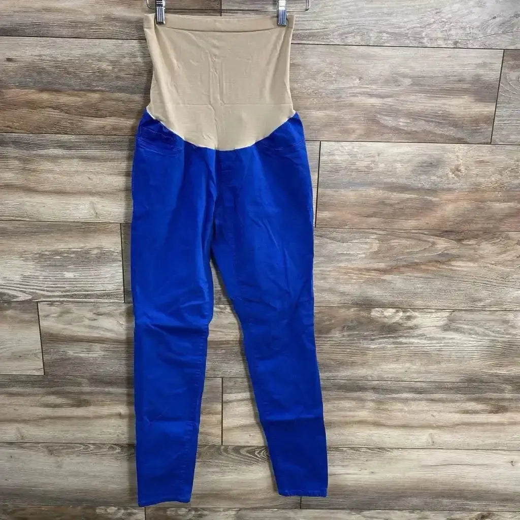 Front flat lay of Motherhood Maternity full-panel maternity pants showing beige full tummy panel and royal blue pant legs on wood floor