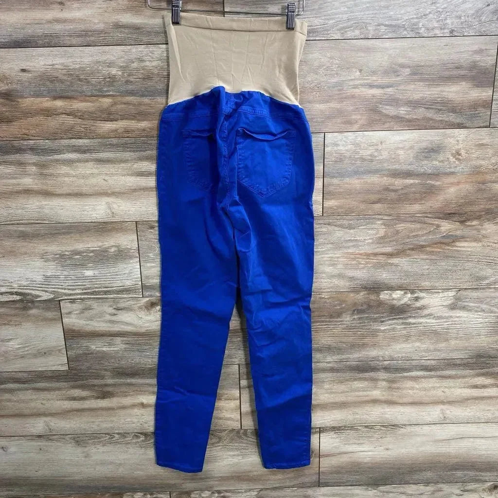 Flat-lay back view of royal blue maternity full-panel pants showing beige full belly panel and back pockets on wood floor