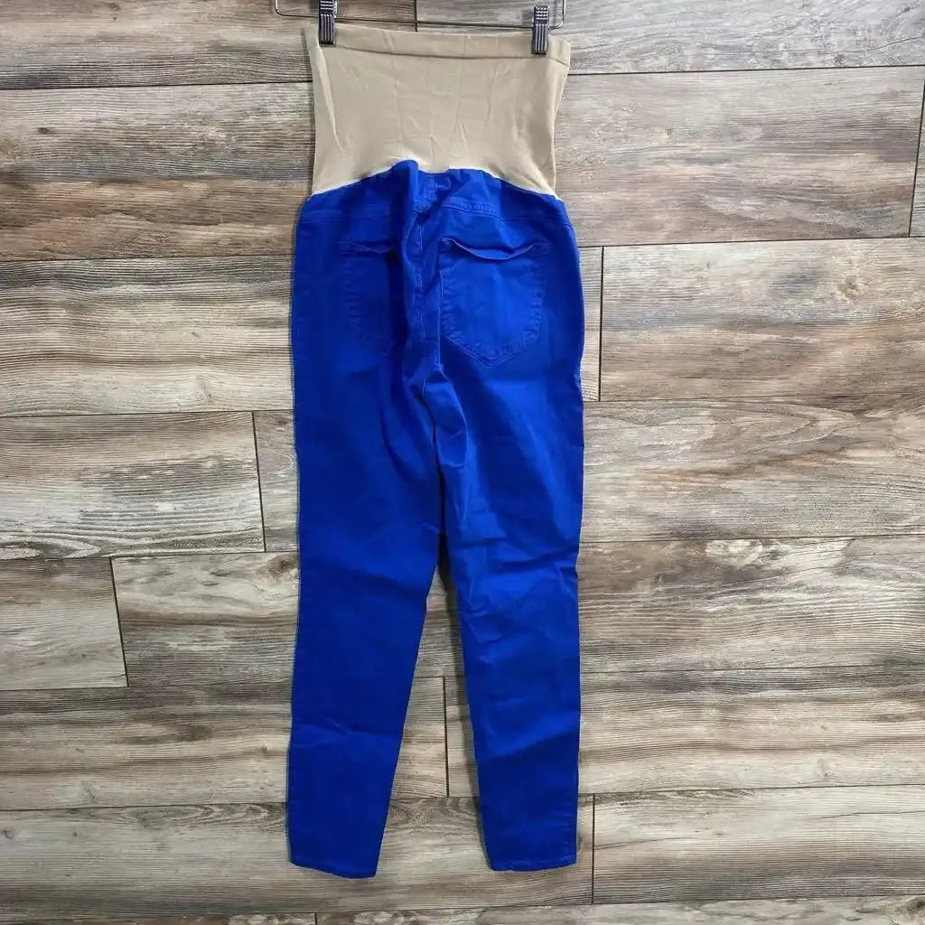 Flat-lay back view of royal blue maternity full-panel pants showing beige full belly panel and back pockets on wood floor