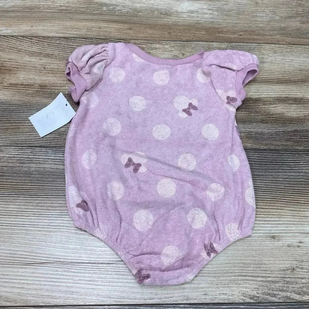Front view of purple terry romper 0-3m showcasing white polka dots and Minnie bow prints with puff sleeves on a wooden floor