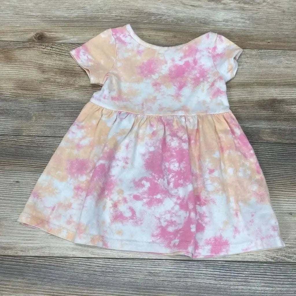 Flat lay of Cat & Jack toddler dress (18M) showing pink and peach tie-dye print, short sleeves and gathered waist on a wood background