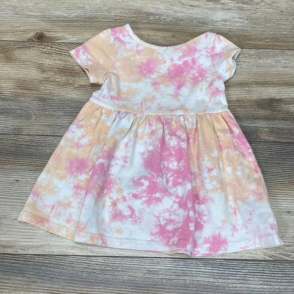 Flat lay of Cat & Jack toddler dress (18M) showing pink and peach tie-dye print, short sleeves and gathered waist on a wood background