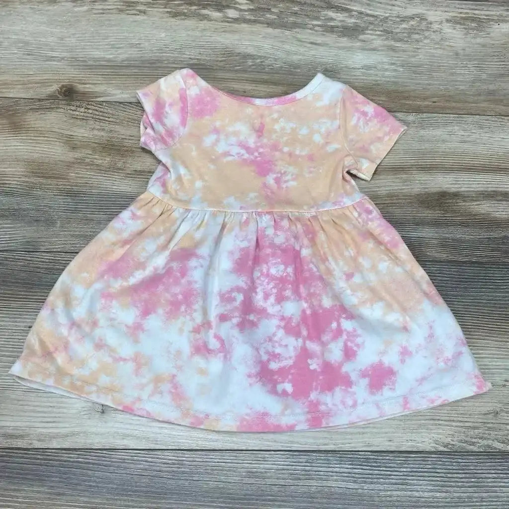 Back view of Cat and Jack Tie Dye Dress in pink and peach short sleeve with gathered skirt on wood plank floor