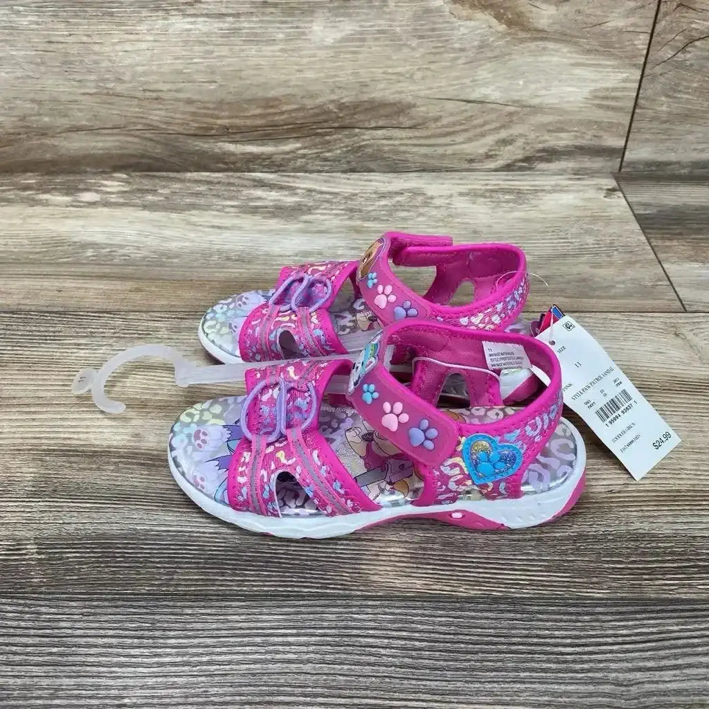 Angled front view of pink toddler Paw Patrol ankle-strap sandal with character print and adjustable strap on white background