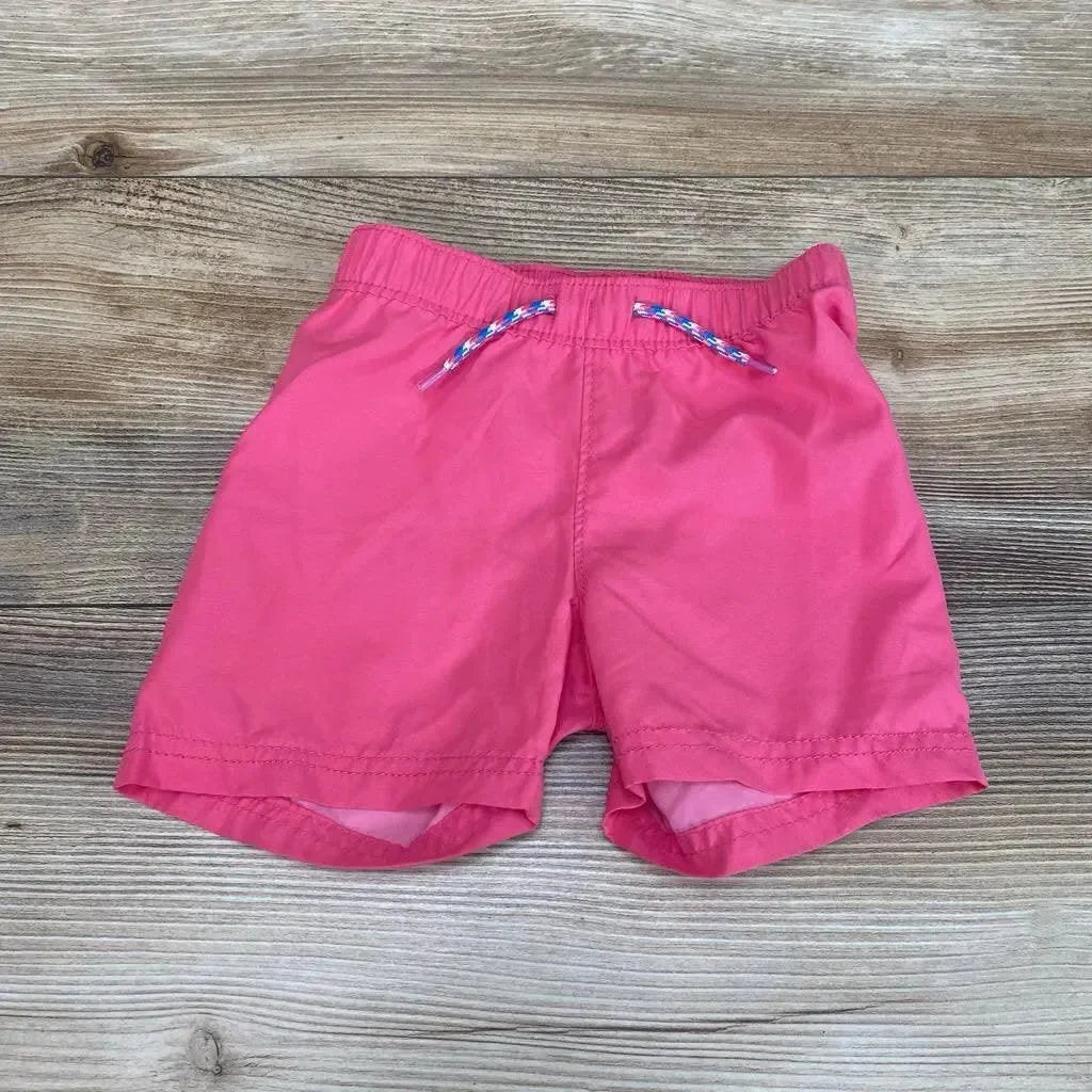 Front view of pink Old Navy toddler swim shorts (12-18m) showing elastic waistband and braided drawstring on wood floor