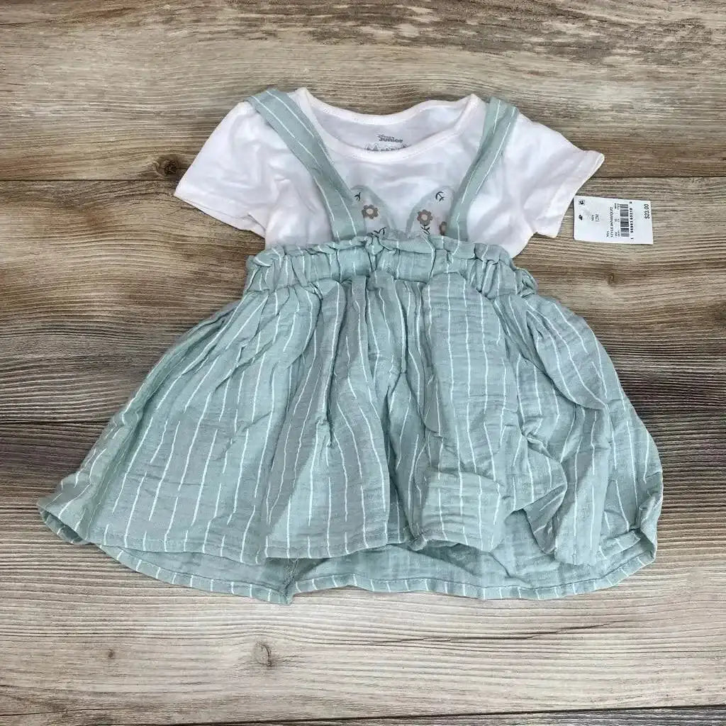 Flat lay of Minnie two piece seafoam striped suspender skirt with elastic ruffle waist and white tee on wood background