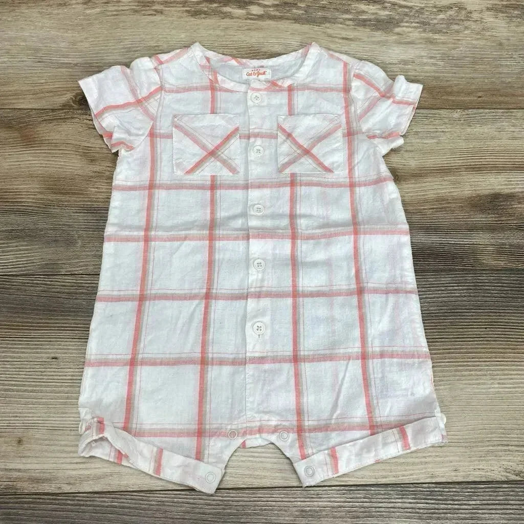 Flat lay, white and pink plaid shortie romper (12M) with buttons, chest pockets, short sleeves, and snap crotch on wood background