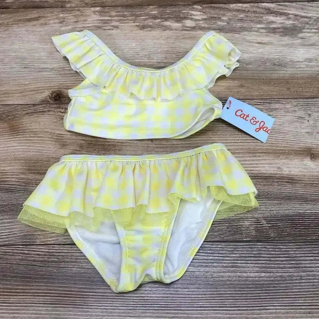 Flat lay of Cat & Jack 2pc Gingham Bikini Set sz 18m showcasing yellow gingham, ruffled top and skirted bottoms