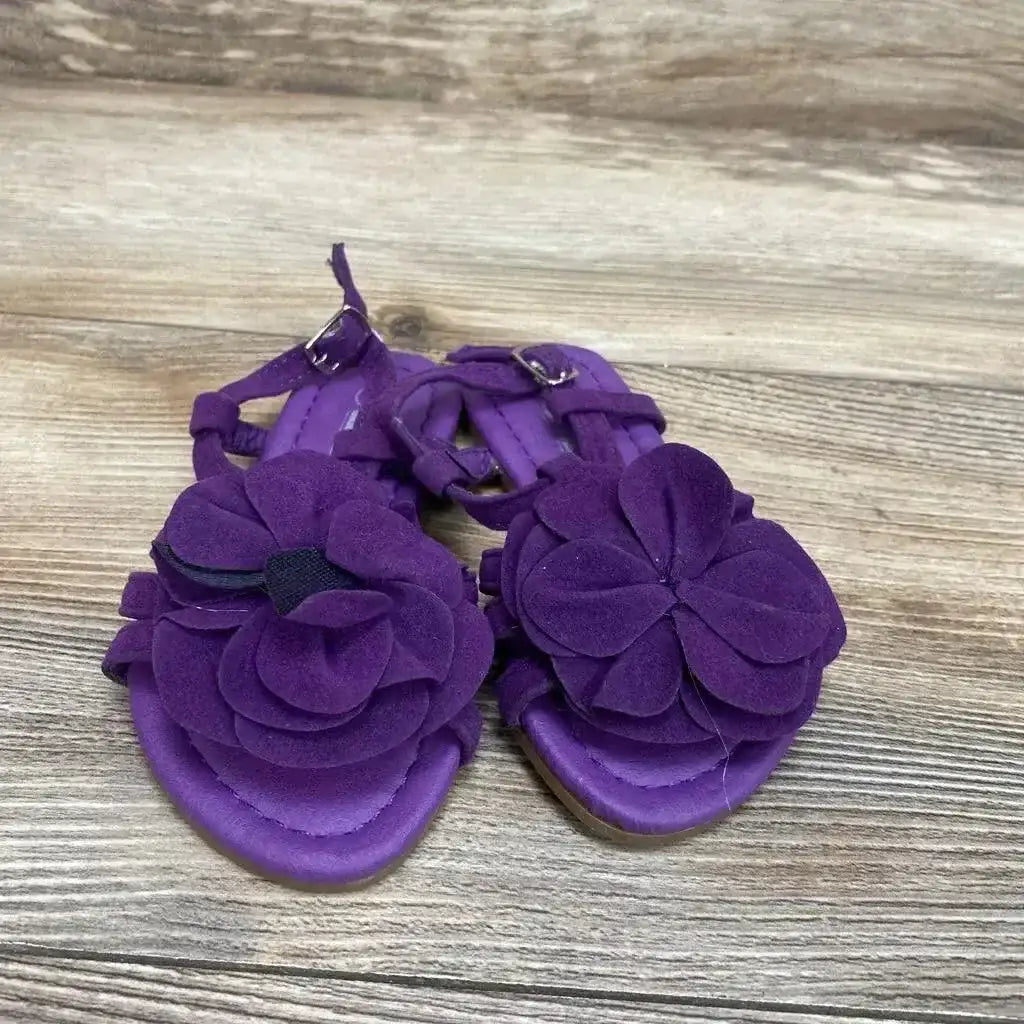 Front view of purple toddler strappy sandals (size 5C) showcasing layered flower appliques with ankle buckles on wood floor
