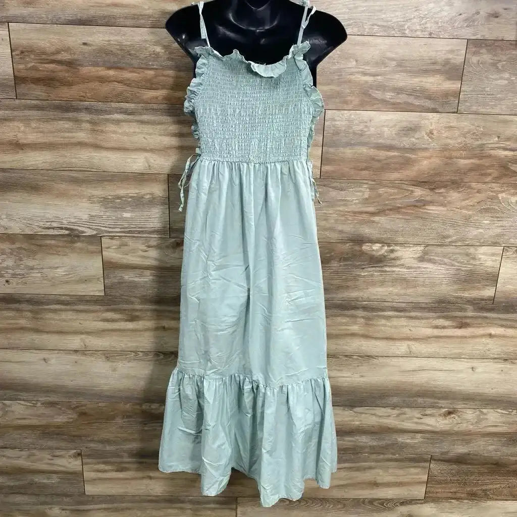 Front of green ASOS smocked ruffle maxi maternity dress showing smocked bodice, ruffle straps and tiered hem on mannequin