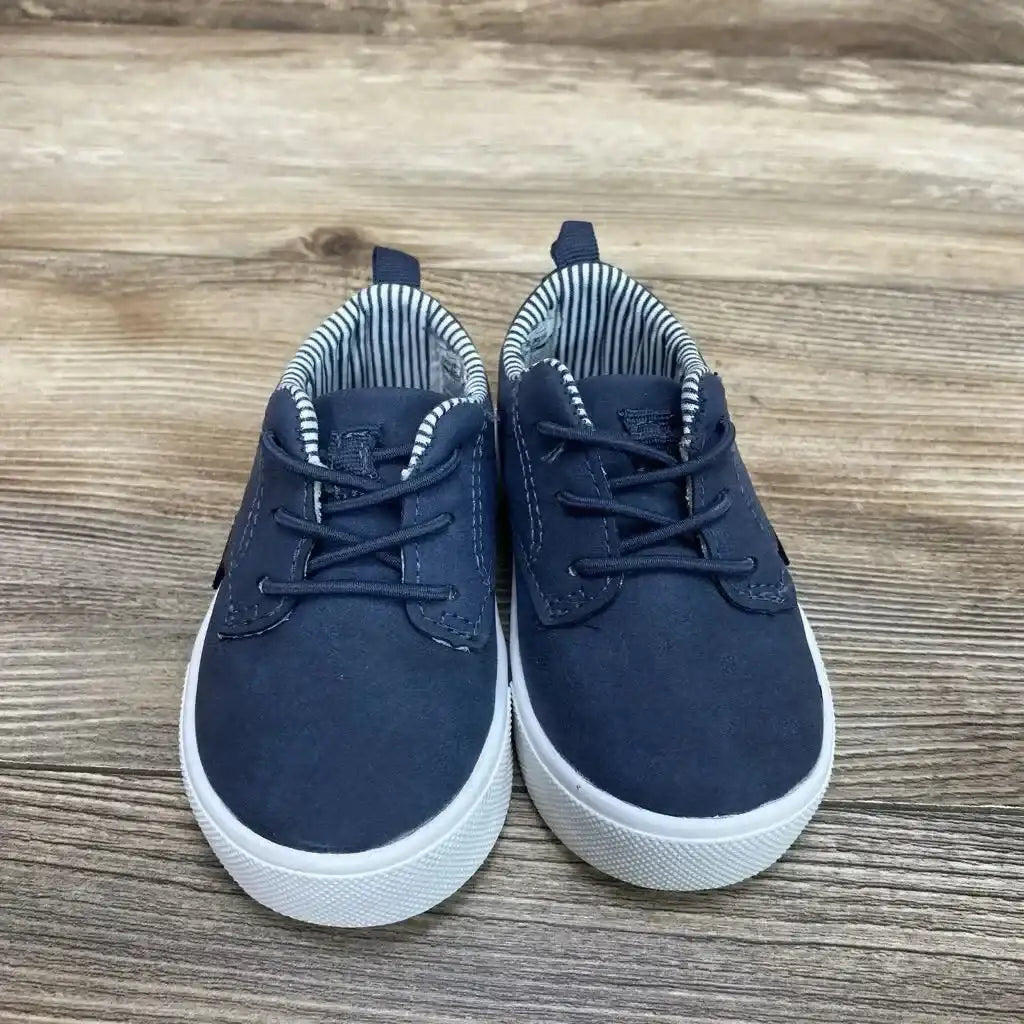 Front view of OshKosh Putney Oxford Casual Sneakers Sz 4c showcasing faux laces, striped lining, and white soles on a wood surface