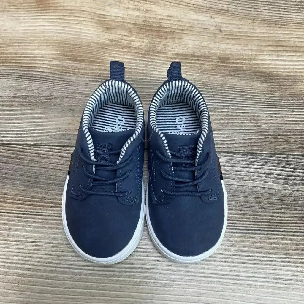 Top view of OshKosh Putney Oxford casual sneakers Sz 4c showcasing faux laces and white soles on wood flooring