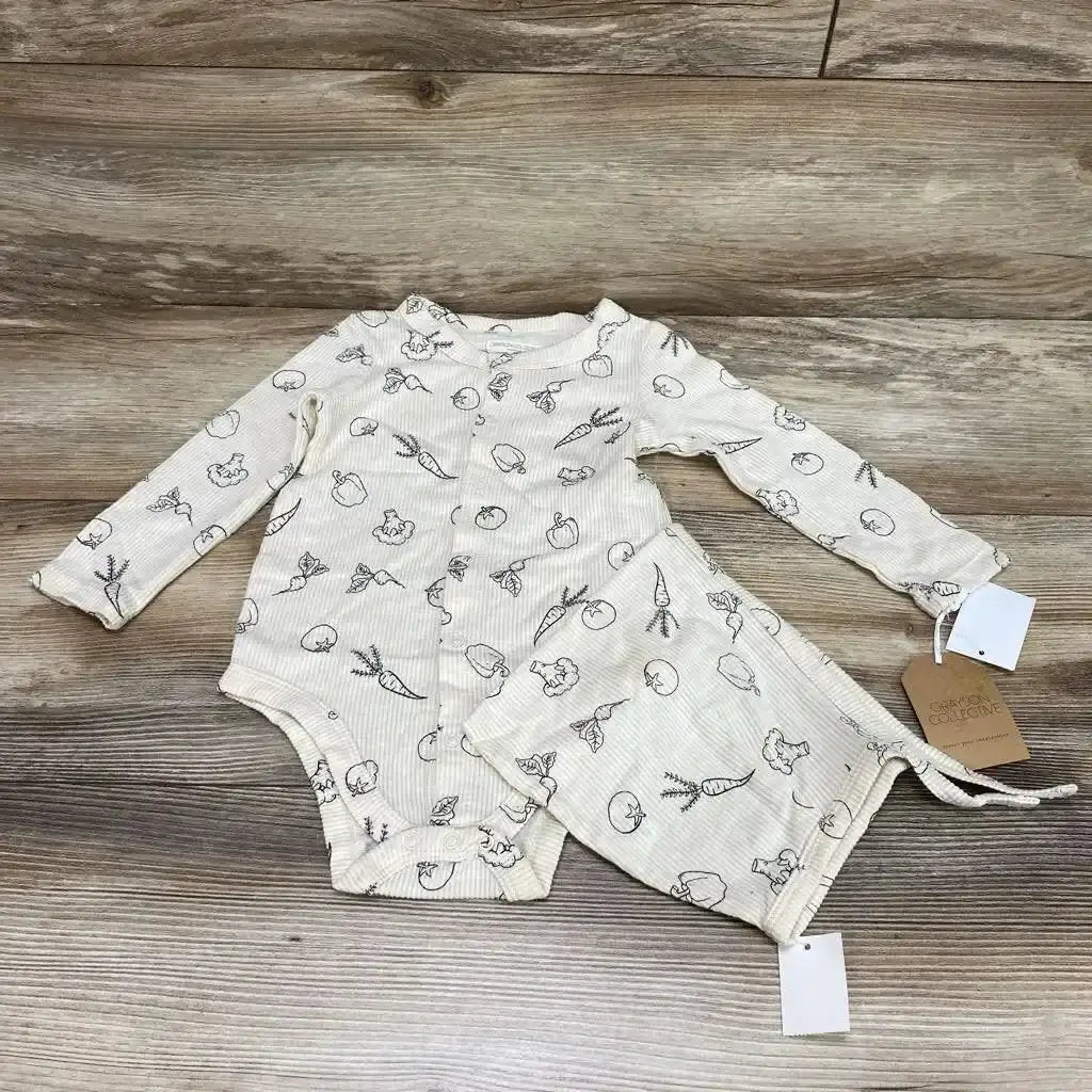 Flat lay of cream Grayson Collective 2-piece ribbed long-sleeve bodysuit and matching bonnet showing vegetable line-drawing print on wood background