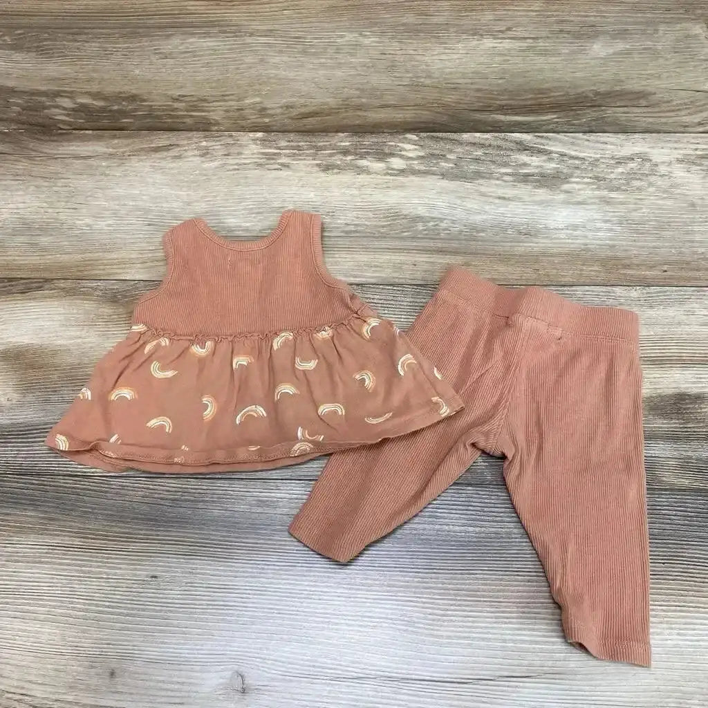 Flat lay of brown 0-3m baby tank top with skirted rainbow print and matching ribbed leggings on wood background