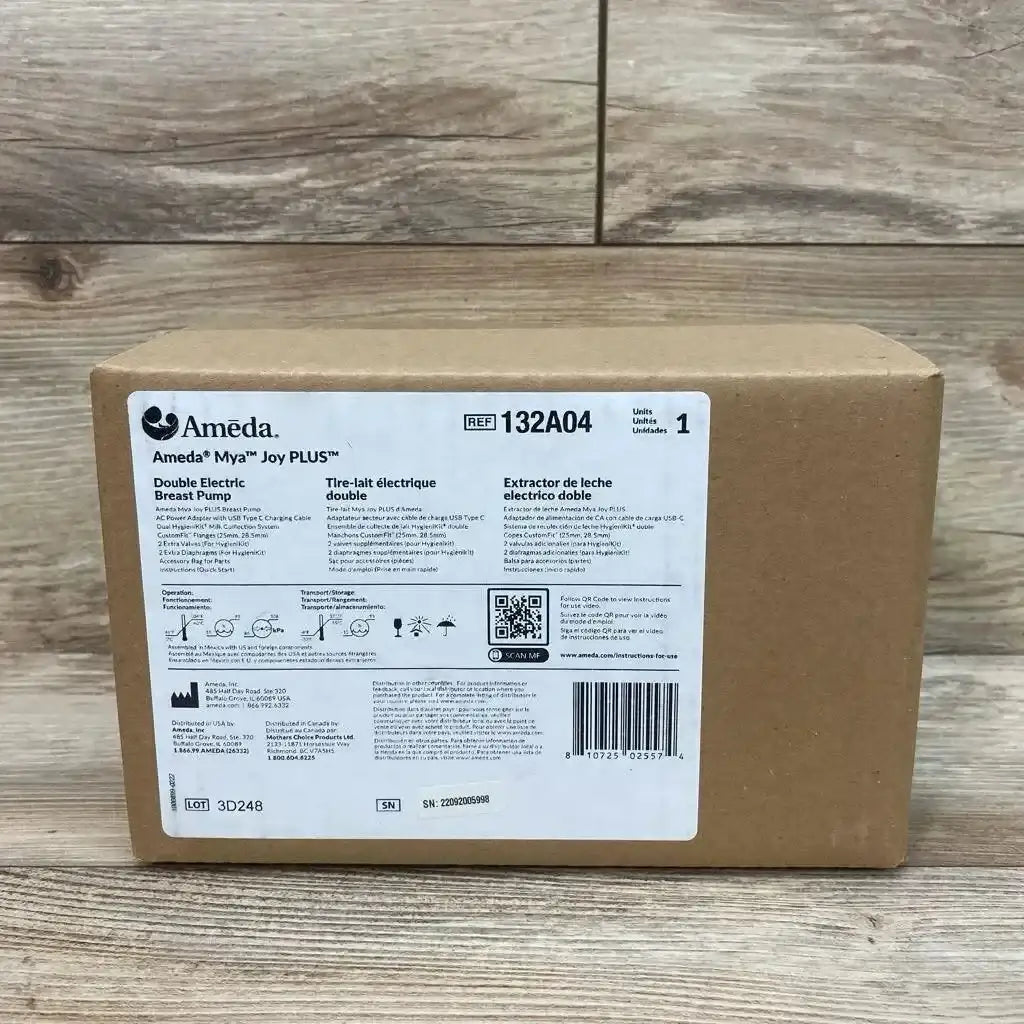 Front view of boxed Ameda Mya Joy PLUS double electric breast pump with label REF 132A04 and barcode on wood floor