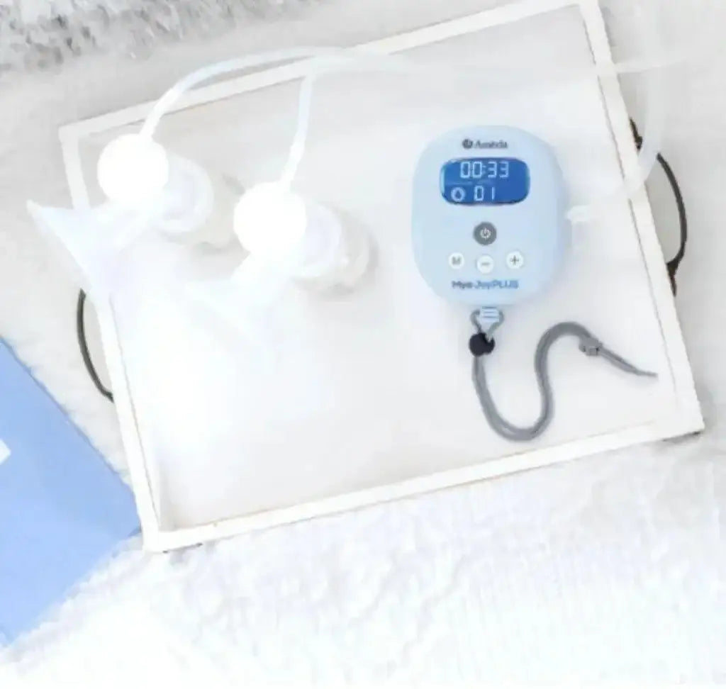 Top-down view of Mya hospital-strength double electric breast pump with two bottles and a blue-lit control unit on a white tray