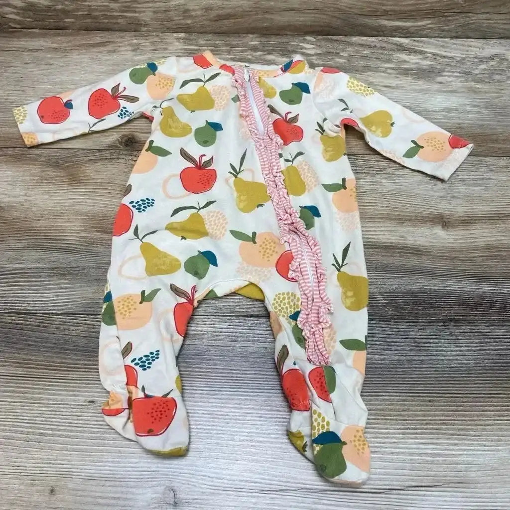 Flat lay of Mudpie fruit ruffle footed sleeper 0-3M with diagonal pink ruffle zipper and fruit print on wood background