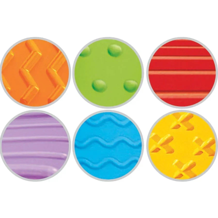 Close-up of Roll and Race ramp textured samples: six colored circular inserts with raised patterns on white background